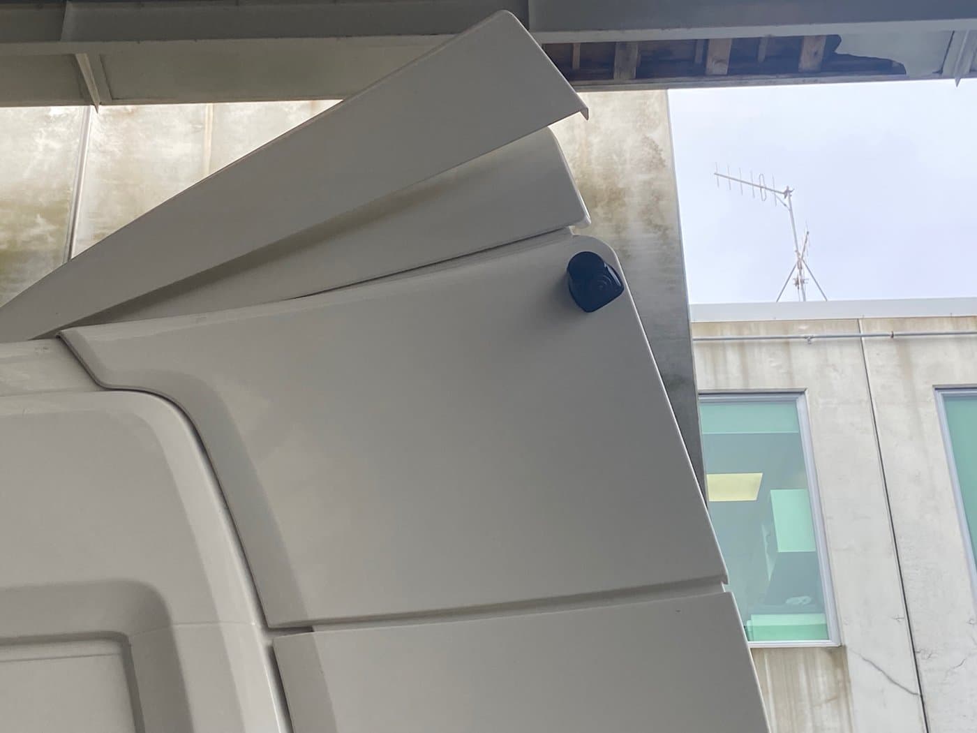 Camera mounted on white Scania cab exterior